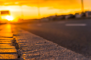 Sunset in the city. Empty highway, close up view from the pavement level