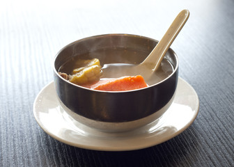 corn and carrot soup in metal bowl