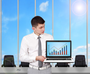 businessman holding laptop