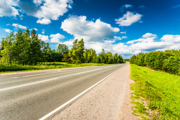 Fototapeta premium Rural road in the woods cloudy day