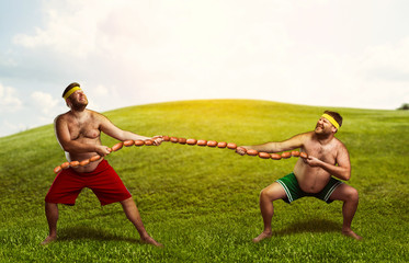 Two men fighting for sausages