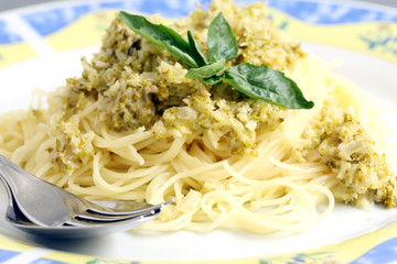 served pasta, spaghetti with cream sauce and zucchini on the plate
