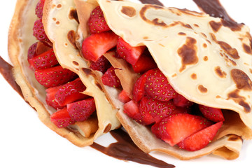 served dessert: isolated pancakes with strawberry and chocolate

