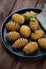 Cast-iron frying pan with hasselback potatoes, studio shot