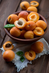Ceramic bowl with ripe apricots, close-up, selective focus