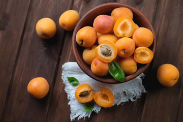 Above view of ripe apricots over dark brown wooden surface