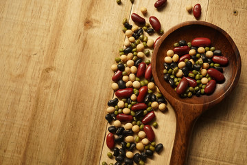 beans and a wooden spoon on the old wood table
