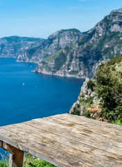 Fototapeta na wymiar Wood empty table over Amalfi Coast scenery.