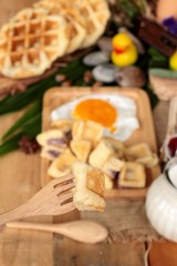 Sweet waffles and fresh milk with jam and egg heart.