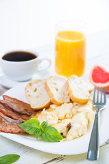 Scrambled eggs with bacon, breakfast