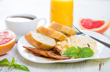 Scrambled eggs with bacon, breakfast