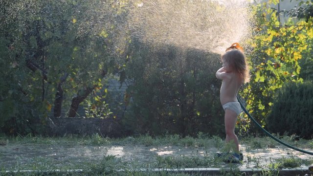 Girl pours water from a hose