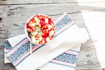 Fototapeta premium oatmeal with poppy seeds, raisins, strawberries and banana
