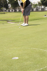 Close up Golf player putting ball