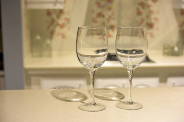 Simple home table setting, glasses in the kitchen interior.