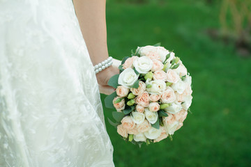 Beautiful wedding bouquet in hands of the bride