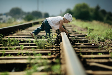 little girl plays on railroad