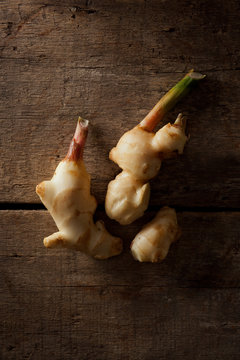 fresh galangal isolated on a wood background