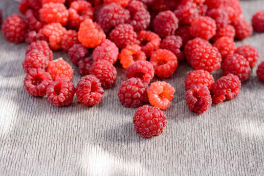 Ripe raspberries scattered on the table