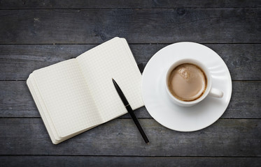 Obraz na płótnie Canvas Coffee cup and note book