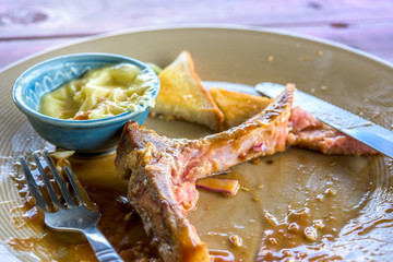 Empty steak dish after food on the table