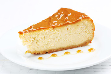 Fresh and tasty caramel cheesecake on white plate