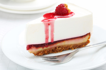 Fresh raspberry cheesecake on white plate