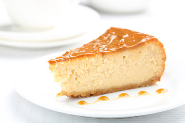 Fresh and tasty caramel cheesecake on white plate