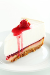 Fresh raspberry cheesecake on white plate