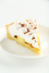 Apple cake with meringue on white plate