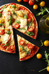 Fresh tasty pizza on black background