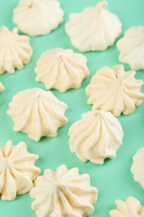 French meringue cookies on green background