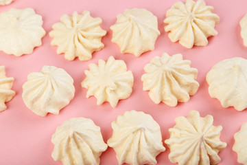 French meringue cookies on pink background