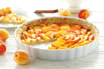 Apricot pie on white wooden background