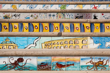 Close up view of some steps decorated with painted ceramic tiles of sea scenes along the seafront of Mazara del Vallo, West Sicily