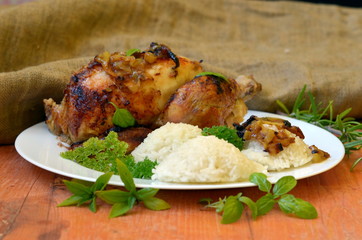 Roasted chicken with herbs and rice on wooden background