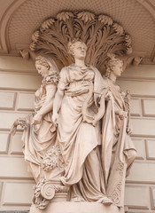Fototapeta premium Allegorical figures - Fertility, Art, Commerce decorated old house on the street in St. Petersburg