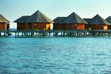 Water villas over ocean background, in resort