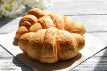 Delicious croissants on table close-up