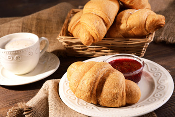 Delicious croissants on plate on table close-up