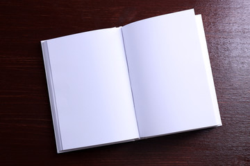 Blank open book on wooden background