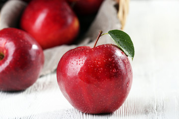 Ripe red apples on table close up