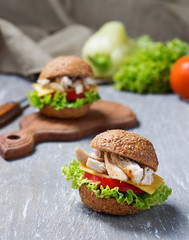 Burger with chicken meat, cheese, tomato