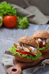 Burger with chicken meat, cheese, tomato