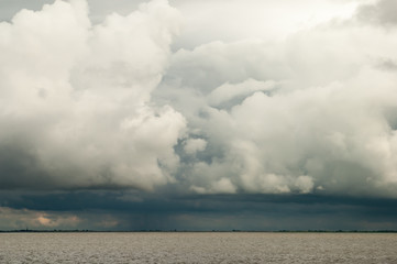 Naklejka na ściany i meble Cloudscape of ominous storm and rain clouds, so called cumulonimbus over Waddensea, Netherlands
