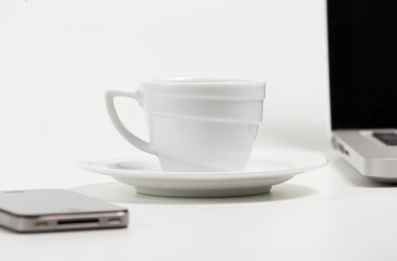 coffee cup, phone and laptop on a white background