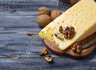 Cheese with nuts in wooden table
