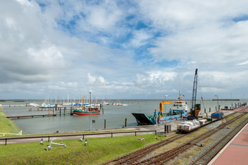 Yachts and supply ship in the harbour of the East Frisian island Langeoog, Lower Saxony, Germany