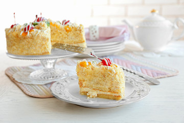 Peace of tasty Butter cake on plate, on color wooden background