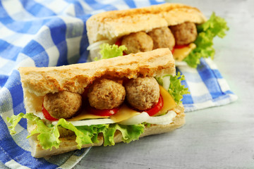 Homemade Spicy Meatball Sub Sandwich on wooden table background